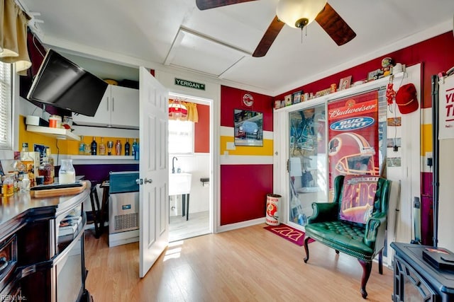 interior space with a ceiling fan and light wood-style flooring
