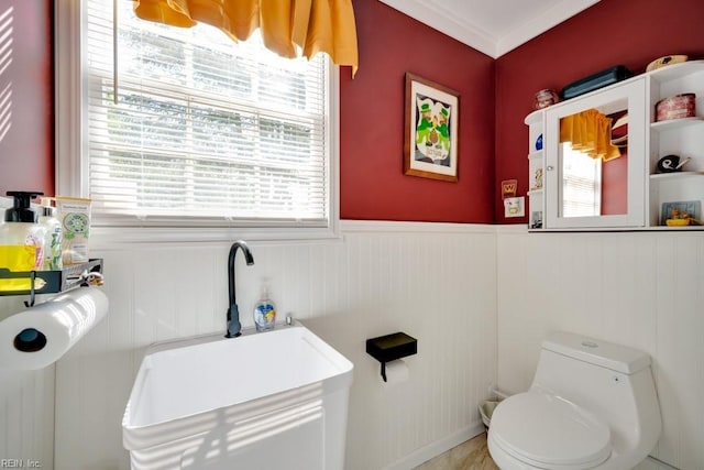 bathroom with wainscoting and toilet