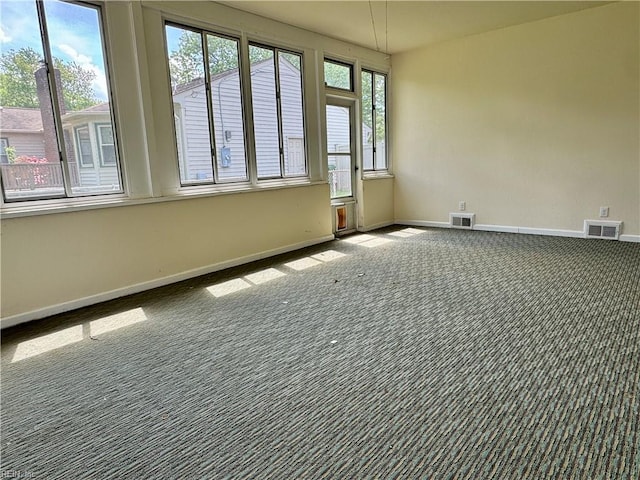 unfurnished room with baseboards, visible vents, and carpet floors