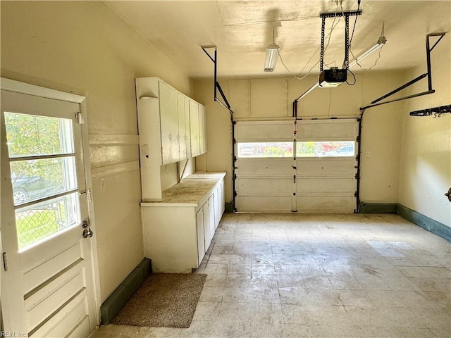 garage with baseboards and a garage door opener