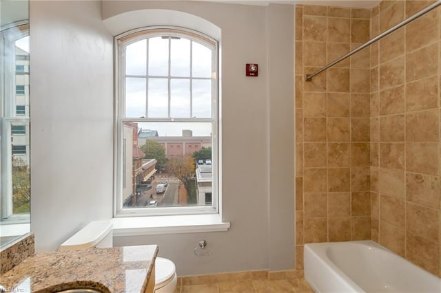bathroom with toilet, bathing tub / shower combination, and vanity