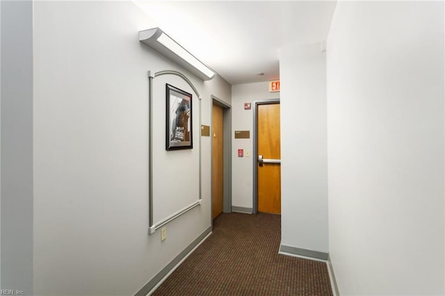 hallway with baseboards and carpet flooring