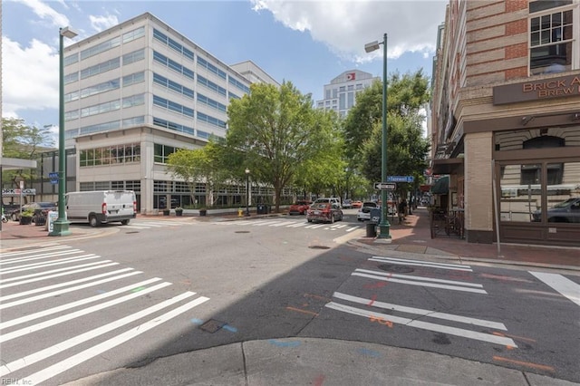 view of street with curbs, sidewalks, and street lights