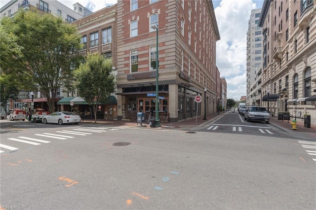 view of street with sidewalks, curbs, and street lights