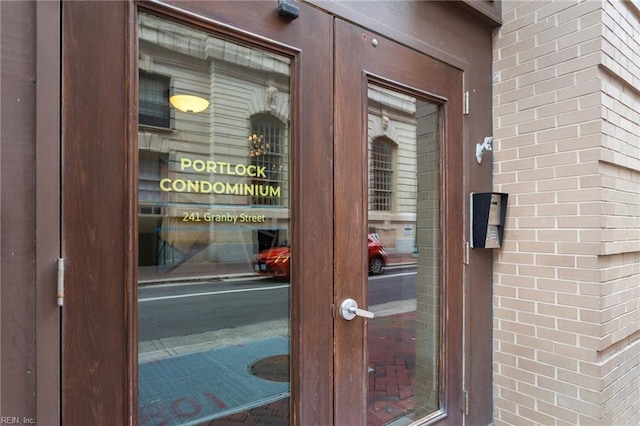 view of exterior entry with brick siding