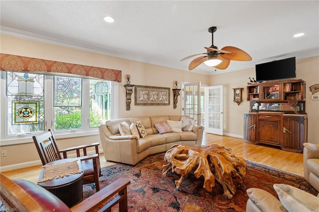 living room featuring ornamental molding and light wood-style flooring