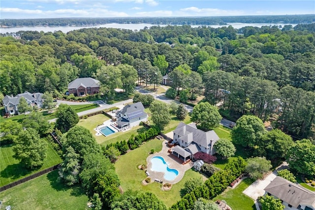 drone / aerial view featuring a water view and a forest view