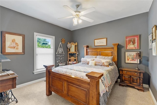 bedroom featuring baseboards, light carpet, and ceiling fan