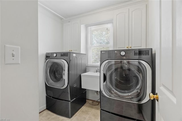 laundry area with washer and dryer, cabinet space, a sink, light tile patterned floors, and ornamental molding