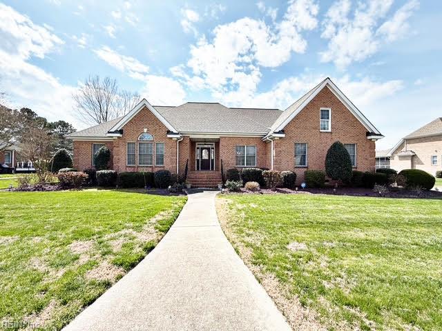 ranch-style house with brick siding and a front yard