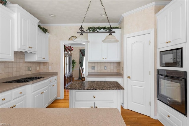 kitchen with tasteful backsplash, light wood-style flooring, white cabinets, black appliances, and ornamental molding