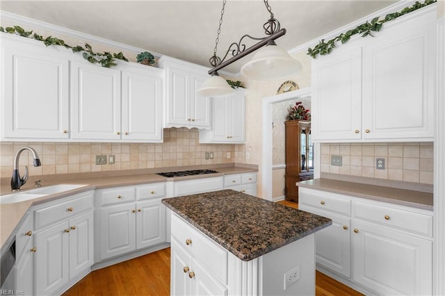 kitchen with a sink, light wood-style flooring, and white cabinetry