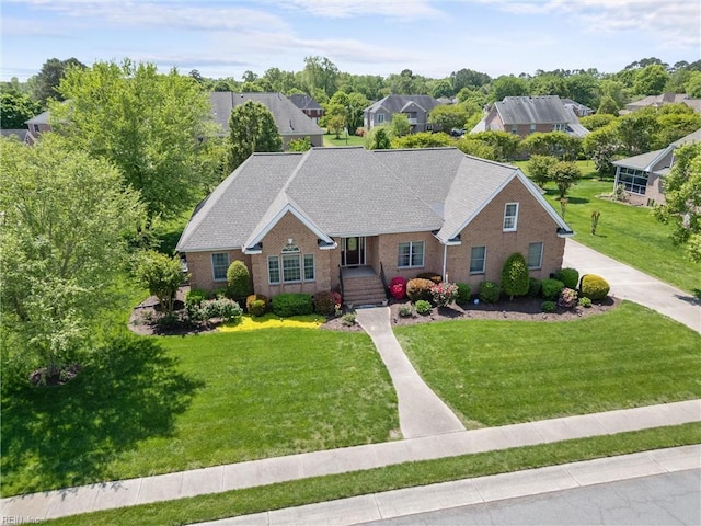 view of front of home featuring brick siding and a front lawn