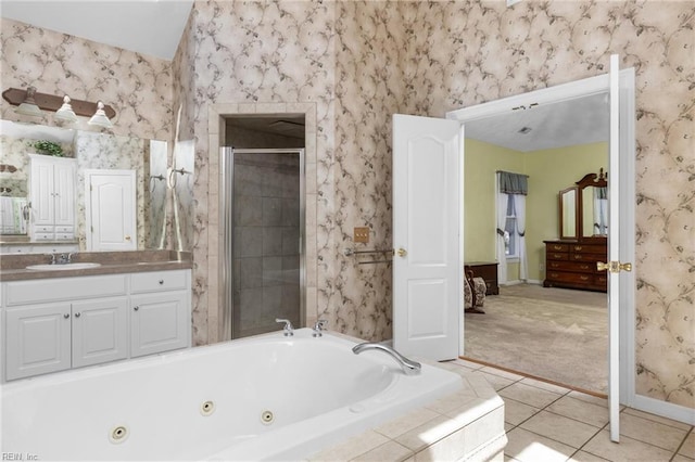 full bath with a shower stall, vanity, baseboards, a tub with jets, and tile patterned flooring