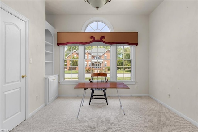 carpeted office featuring baseboards