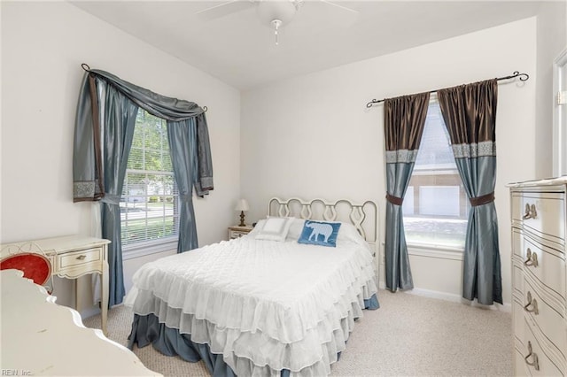 bedroom featuring baseboards, a ceiling fan, and light carpet