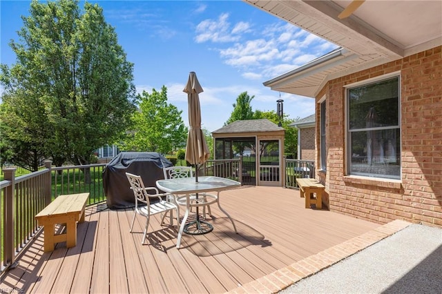 wooden deck with a gazebo and outdoor dining area