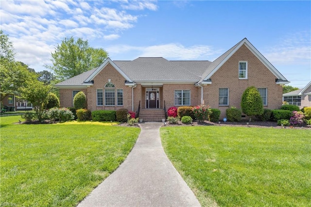 view of front of house featuring a front yard and brick siding