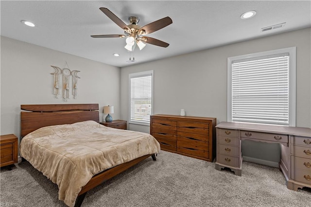 bedroom with visible vents, light colored carpet, and recessed lighting