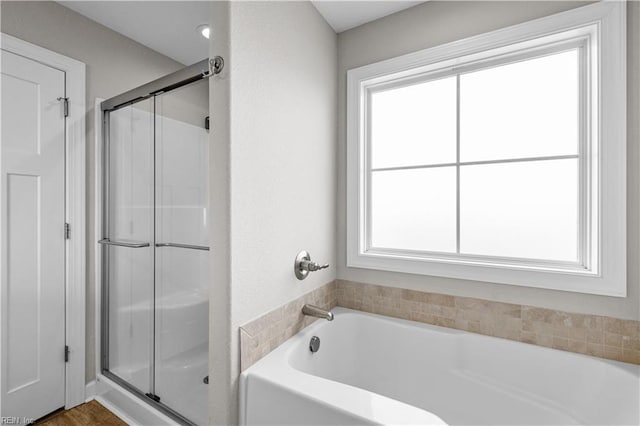 full bath featuring a garden tub and a stall shower