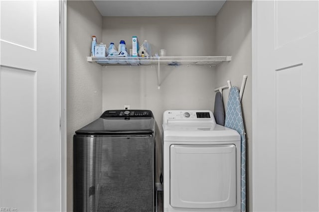 laundry room with separate washer and dryer and laundry area
