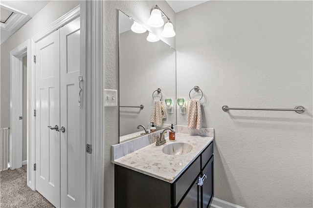 bathroom featuring a textured wall and vanity