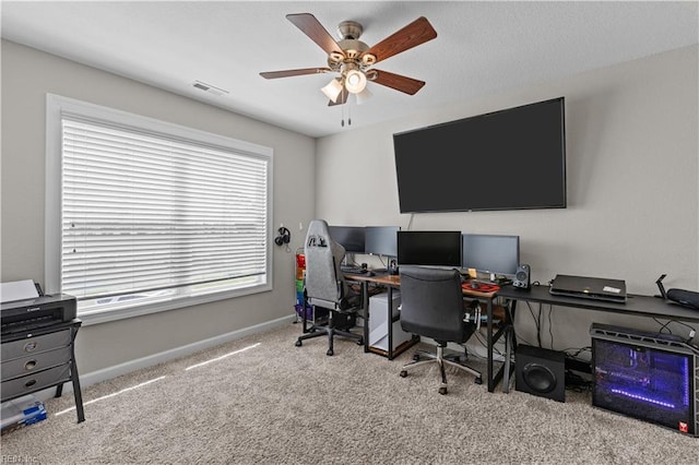 home office featuring visible vents, ceiling fan, carpet, and baseboards
