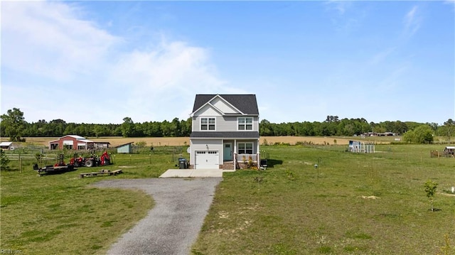 view of front facade with driveway, a front yard, and an attached garage