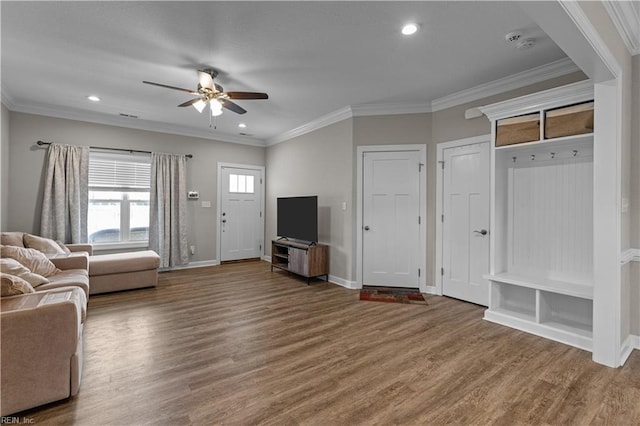 living area with crown molding, a ceiling fan, wood finished floors, and baseboards