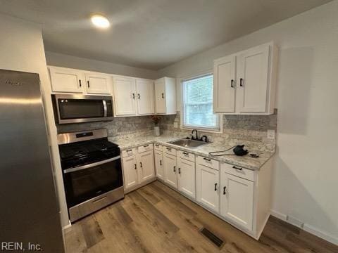 407 Wilson Ct, Suffolk, VA 23434 - kitchen with appliances with stainless steel finishes, visible vents, white cabinets, and a sink