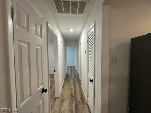 407 Wilson Ct, Suffolk, VA 23434 - hall with light wood finished floors, visible vents, and baseboards