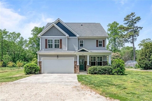 craftsman-style home with concrete driveway, a front lawn, an attached garage, and covered porch
