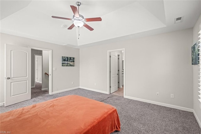 carpeted bedroom featuring a ceiling fan, visible vents, and baseboards