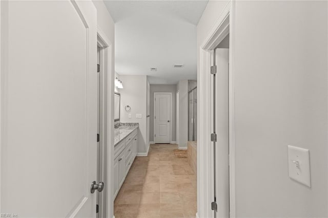 full bathroom with visible vents, vanity, a stall shower, and baseboards