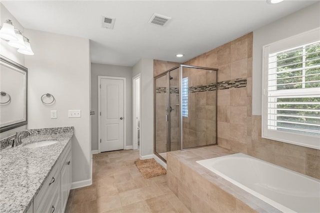 full bath with a shower stall, a bath, vanity, baseboards, and visible vents