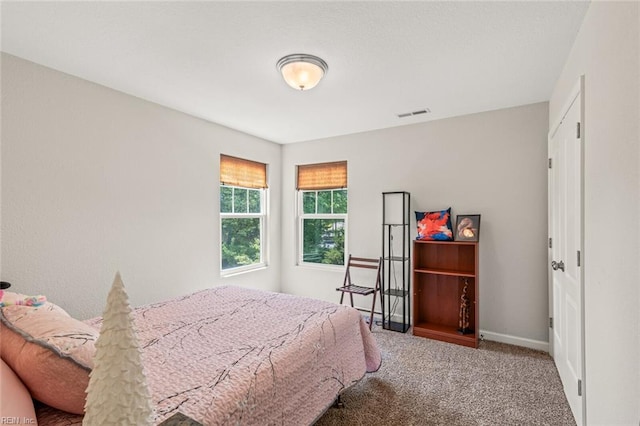 bedroom featuring baseboards, visible vents, and carpet flooring
