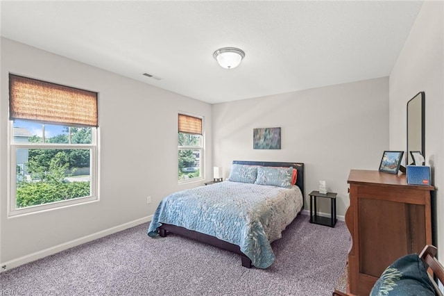 bedroom featuring baseboards, visible vents, and carpet flooring
