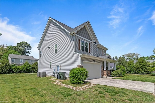 view of side of home with driveway, cooling unit, a yard, and an attached garage