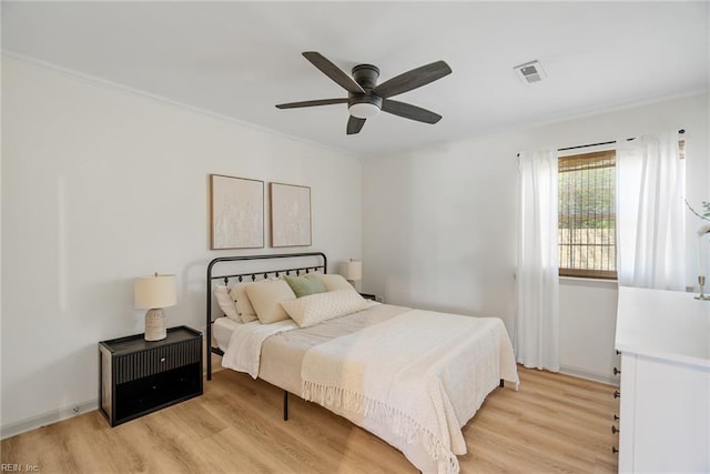 bedroom featuring visible vents, ceiling fan, and light wood-style flooring