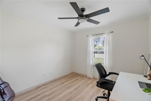 office area with ornamental molding, ceiling fan, light wood-style flooring, and baseboards
