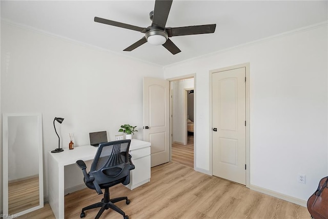 office space with light wood finished floors, ceiling fan, and ornamental molding