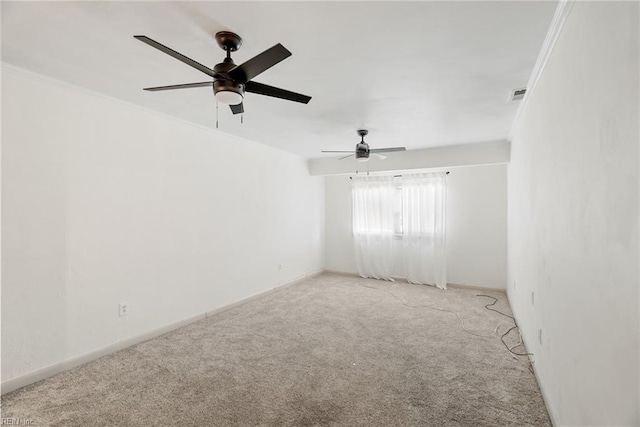 carpeted spare room with visible vents and ceiling fan
