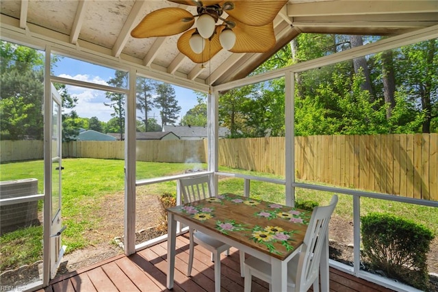 sunroom featuring ceiling fan and plenty of natural light