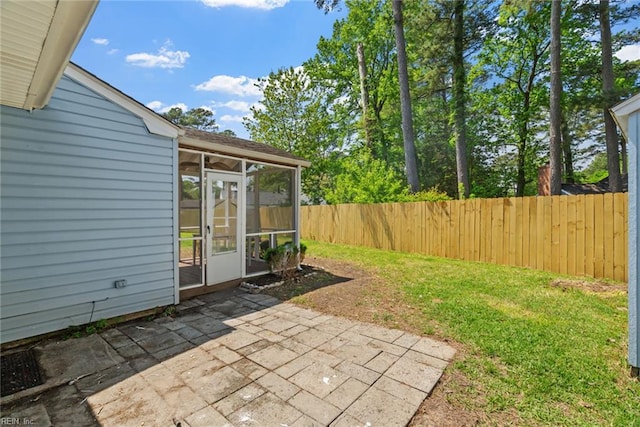 view of patio featuring a fenced backyard and a sunroom