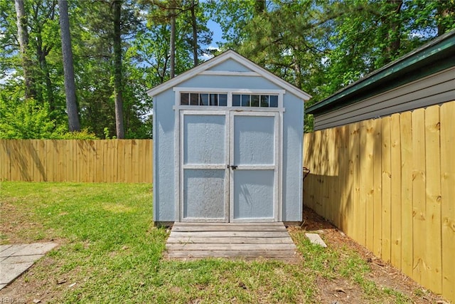 view of shed featuring fence