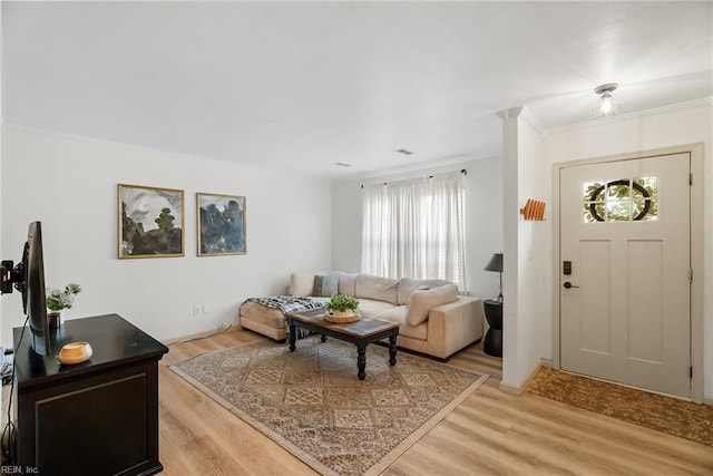 living room featuring light wood-style floors and ornamental molding