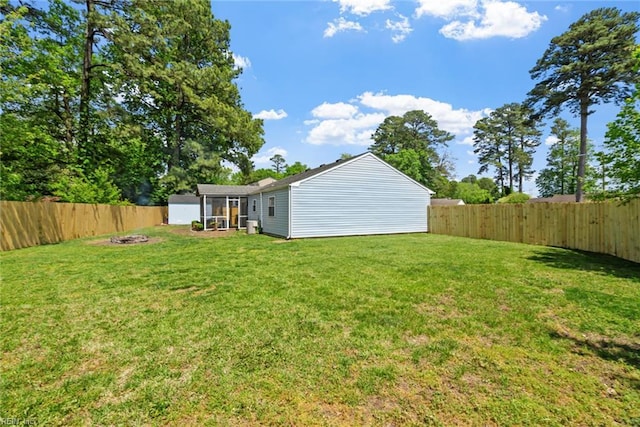 view of yard with a fire pit and a fenced backyard