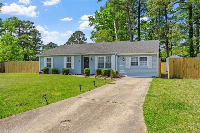 single story home with fence, concrete driveway, and a front lawn
