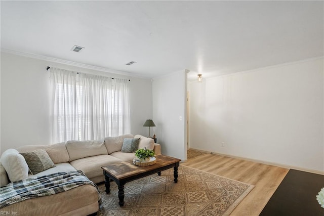 living room featuring ornamental molding, wood finished floors, and visible vents