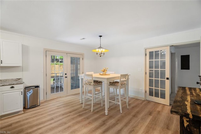 dining area with french doors and light wood-style flooring